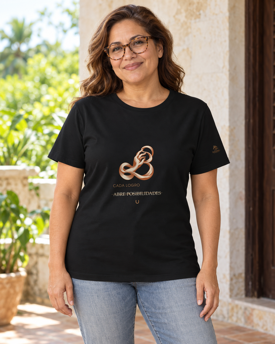 Persona generada con IA mostrando la camiseta negra RIENDAS Terapia Ocupacional para mujer. Representación ilustrativa del diseño Cada logro abre posibilidades.